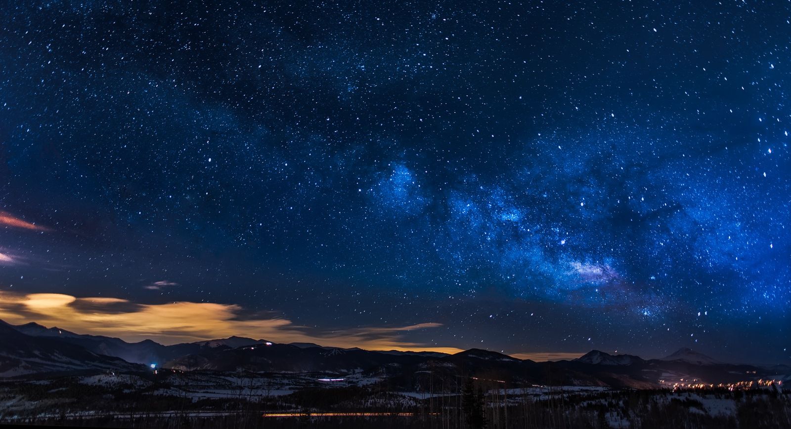 Night sky over a mountain ridge, the kind of hero photograph a headline sits on