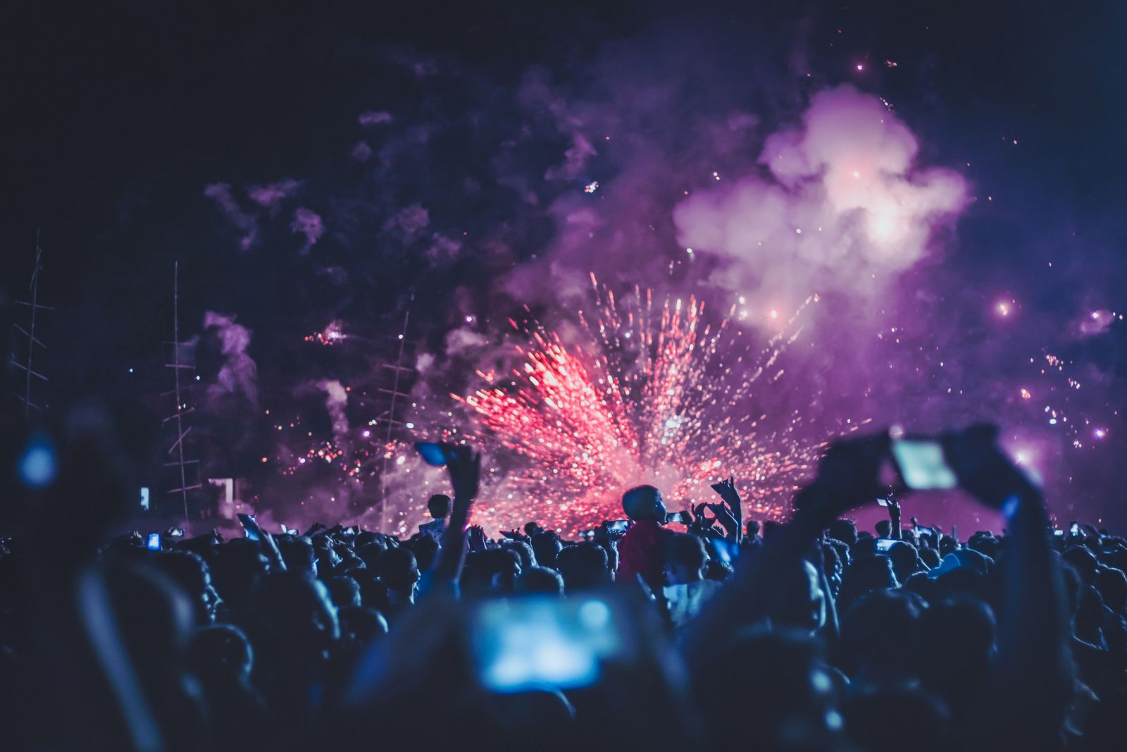 Stage lights and confetti over a crowd, a moving backdrop for caption text